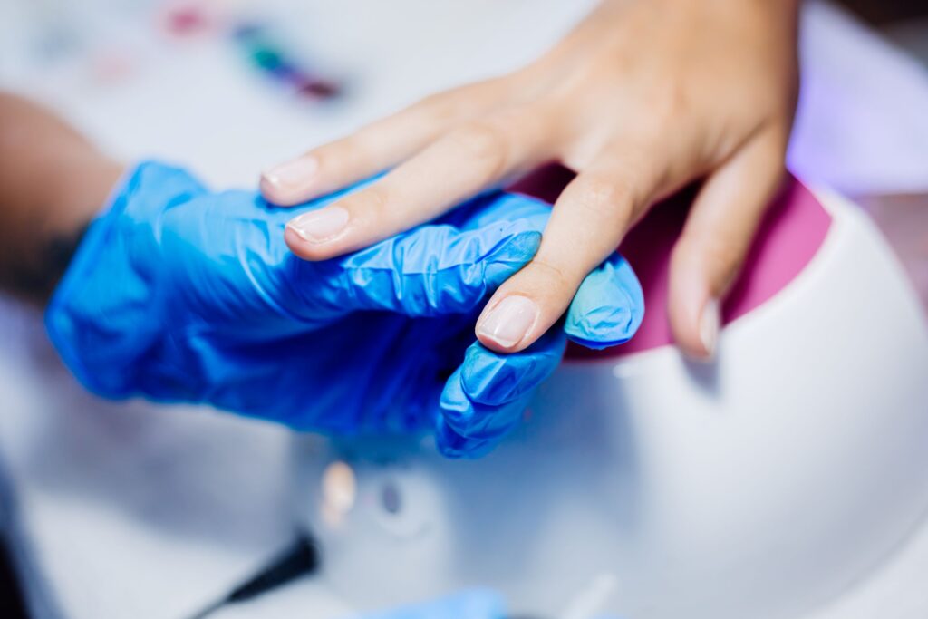 Técnico trabajando la retirada de gel mediante torno en zona de cutícula.